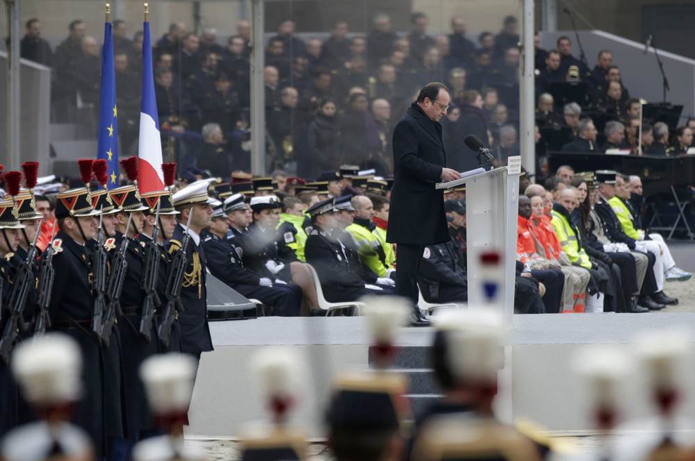 French President Francois Hollande delivers a speech during a ceremony to pay a national homage to the victims of the Paris attacks at Les Invalides monument in Paris
